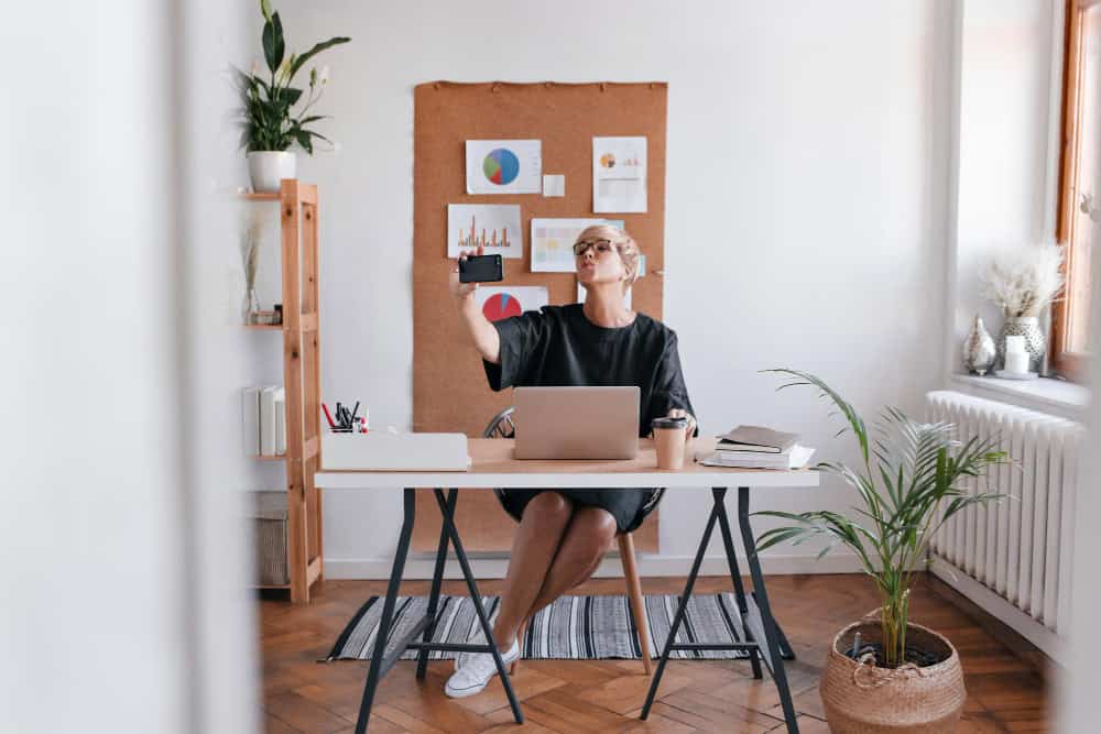 Person using workspace furniture in a bright, organized home office that promotes focus and clarity.