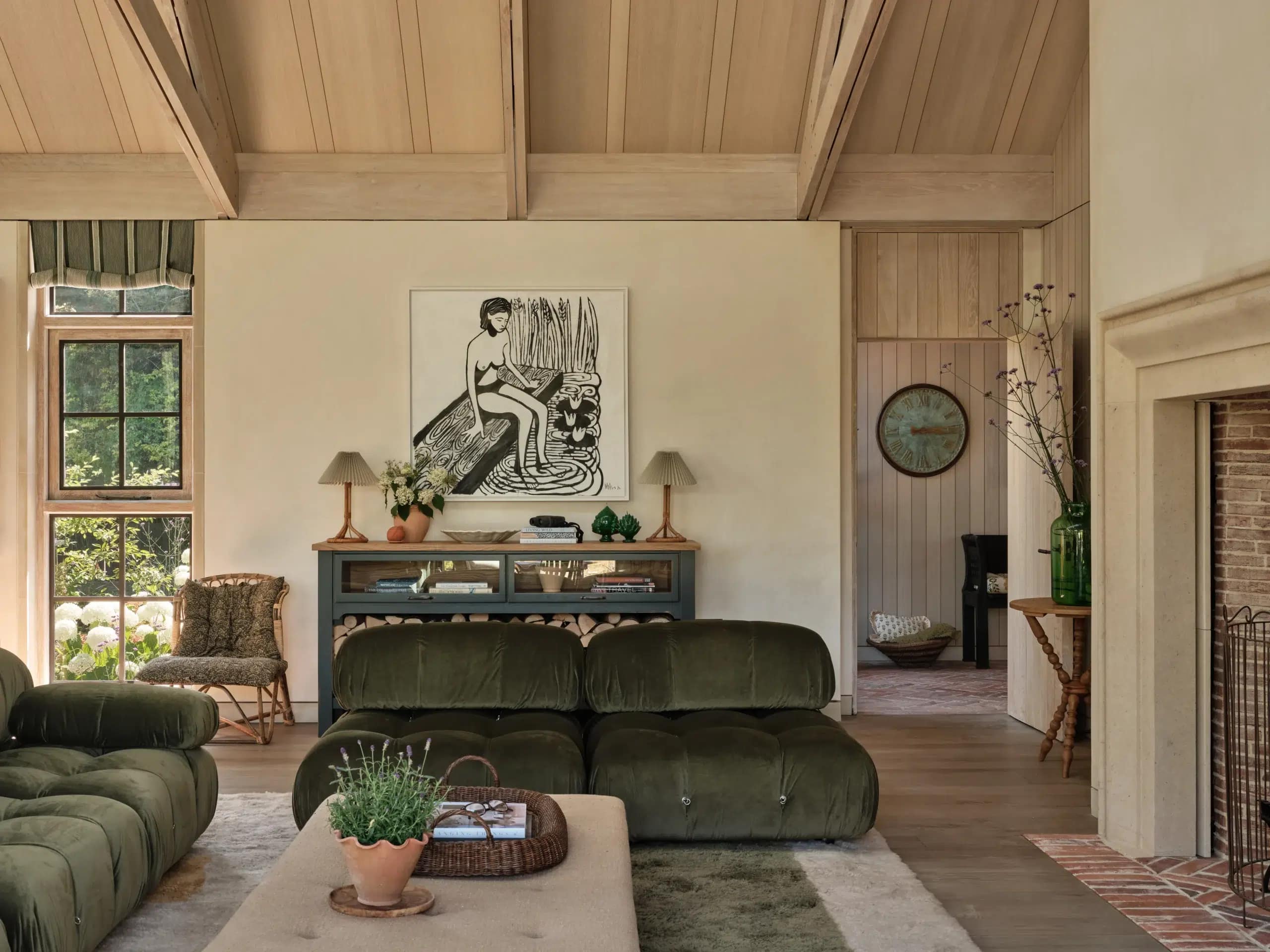 The open-plan sitting room with a green velvet Camaleonda sofa