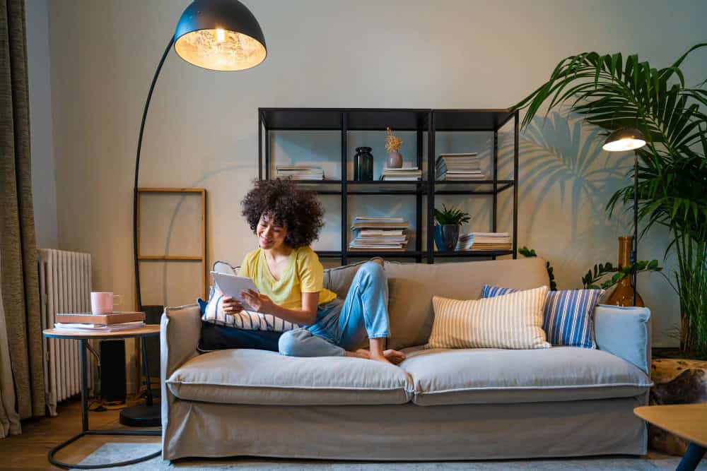 Accent chair, bookshelf, and pendant light used as visual cues to define zones, showcasing smart split living room ideas for open homes.