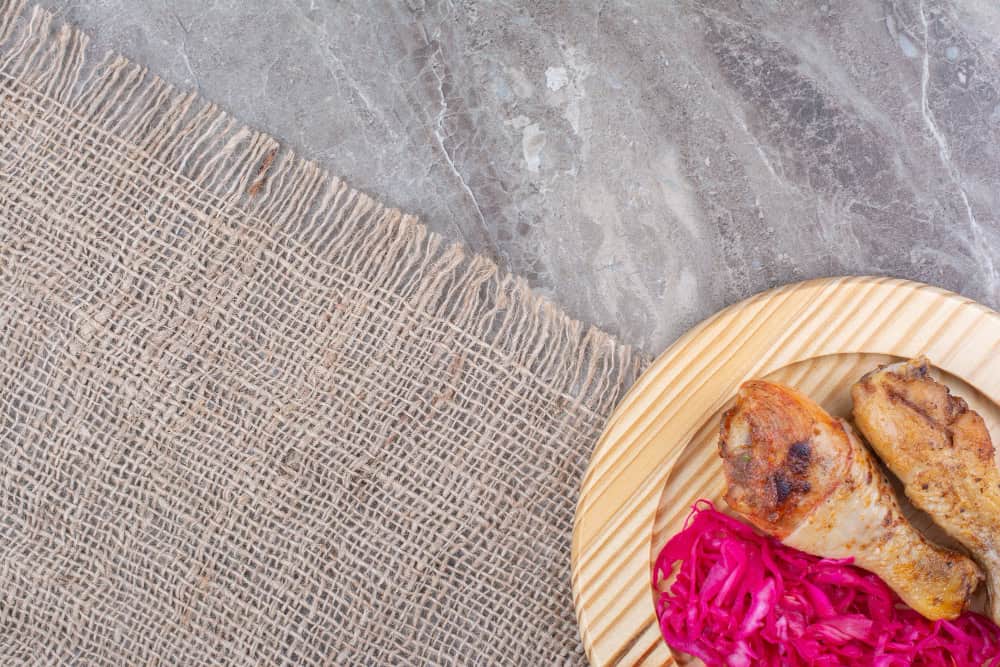 Marble dining table styled with woven placemats and wooden trays, creating contrast and depth.