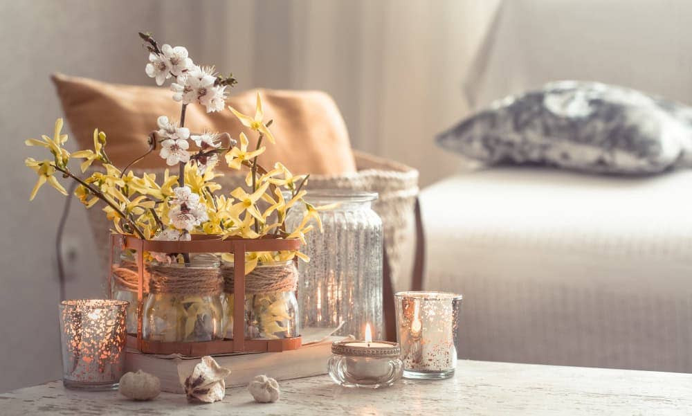 Seasonally styled marble dining table with pastel flowers and candles, bringing fresh energy indoors.
