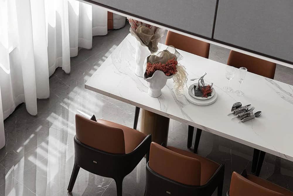 White marble dining table with subtle veining, styled with earthy tones and clean modern decor.”