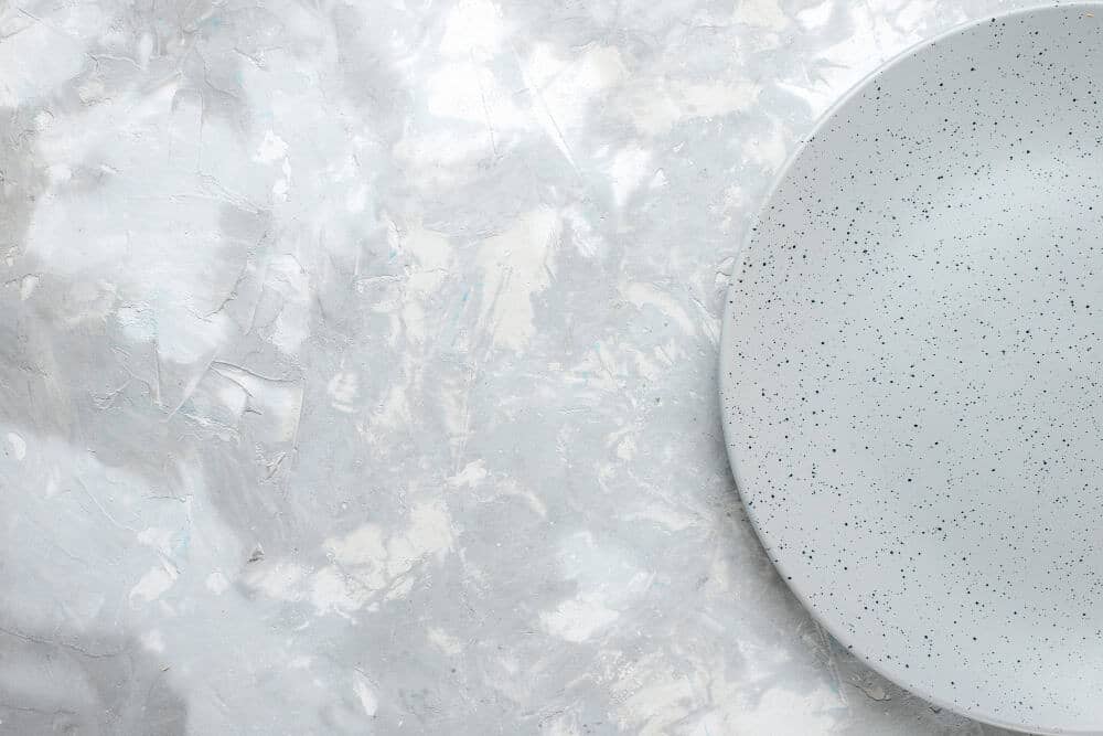 Close-up of marble dining table surface showing natural veining and smooth, polished texture.