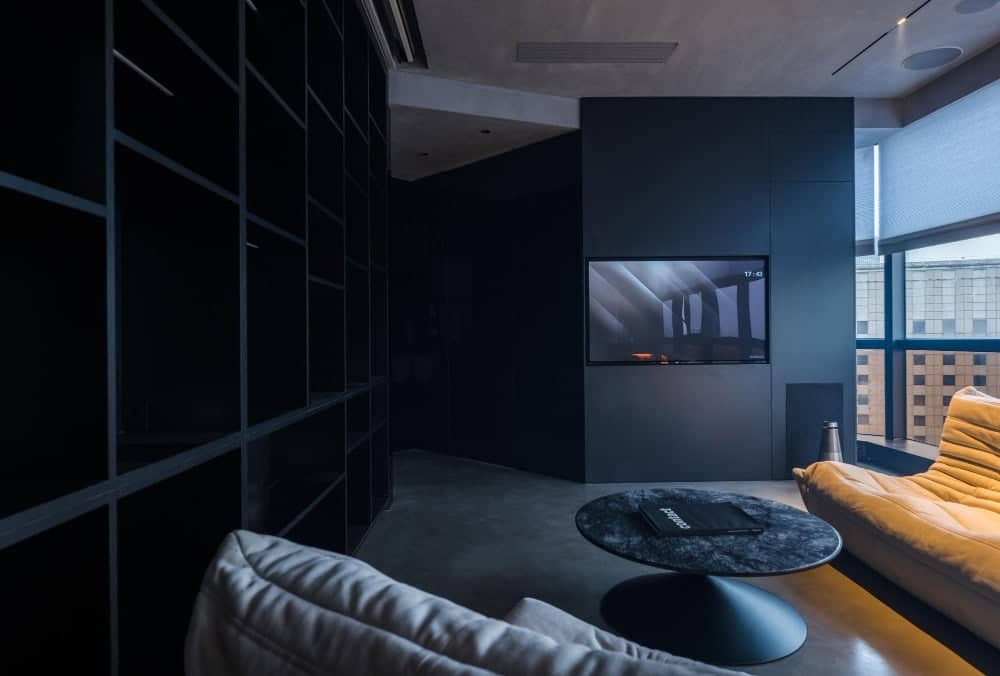 Dark navy wall design showcasing small living room ideas with TV that blends seamlessly into modern decor.