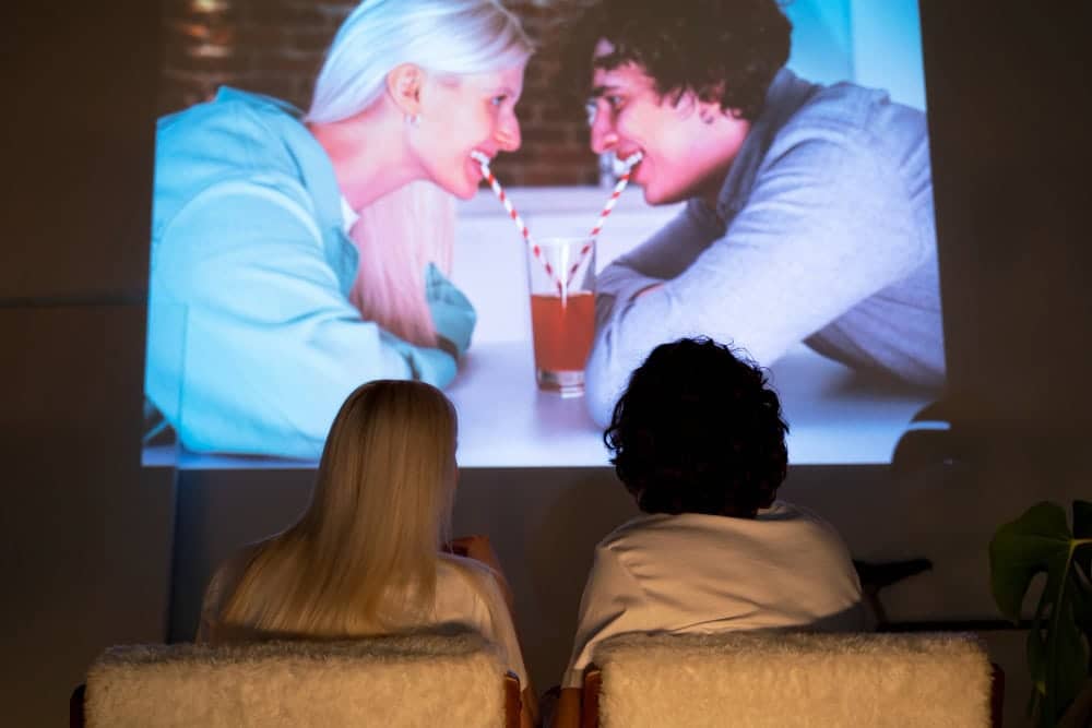 Projector setup illustrating minimalist small living room ideas with TV alternatives using a blank wall as screen.