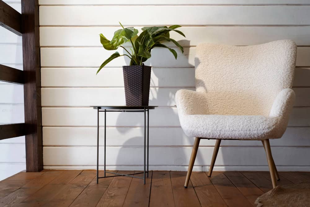 Luxurious full sheepskin lounge chair surrounded by earthy tones and natural textures, creating a calm, inviting corner.