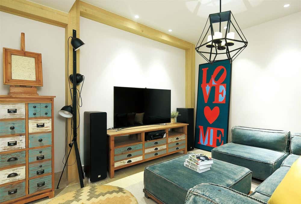 Bold color palette with TV wall showcasing creative small living room ideas with TV and patterned wallpaper.