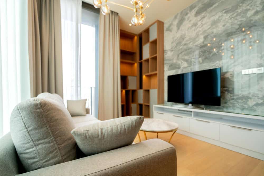 Textured wall panels and natural materials highlighting cozy small living room ideas with TV for modern homes.