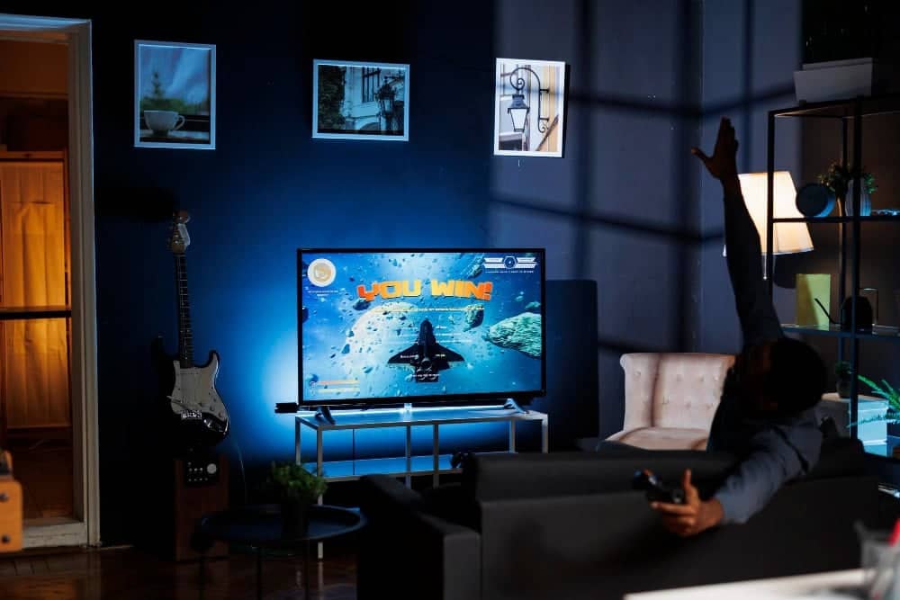 DIY TV stand with soft LED lighting behind the TV, creating a cinematic glow in a cozy living room.