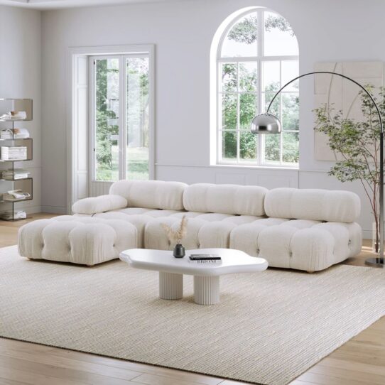 A contemporary living room featuring the Camaleonda Replica sofa in elegant leather upholstery, highlighting its modular design and plush cushions.