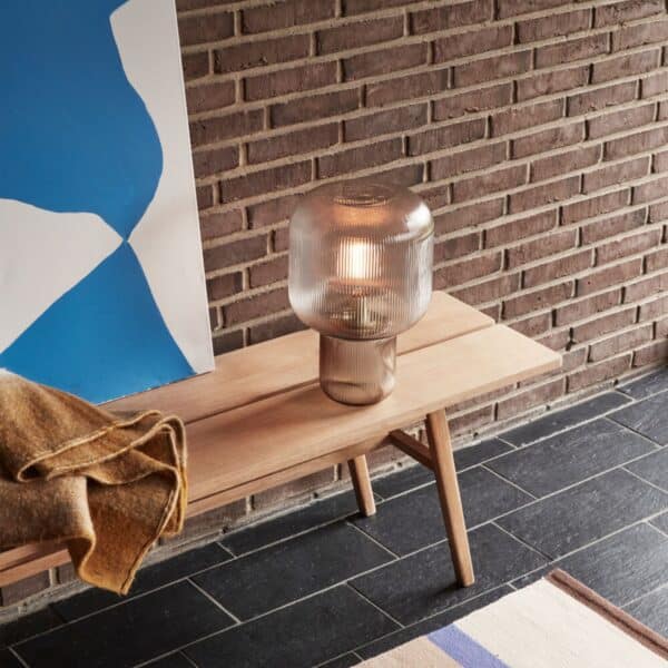 Pomelo Table Lamp is turned on and emits a warm yellow light.