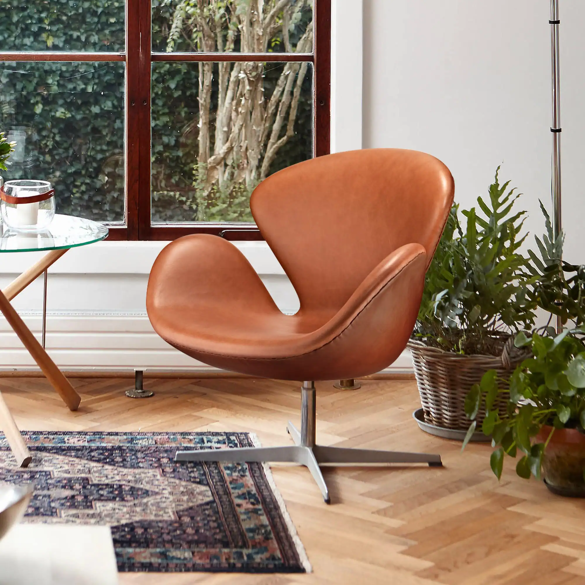 Brown leather swivel chair in a room setting.