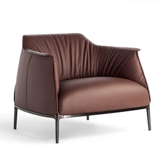 The Archibald Armchair Replica offers a classic look with a modern twist, featuring a curved backrest and upholstered seating cushion in premium leather.