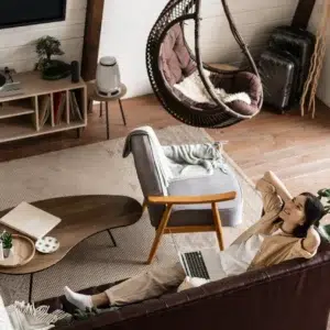 happy relaxed asian woman laying couch home with laptop listening podcast enjoying weekend - Living Space Sofa