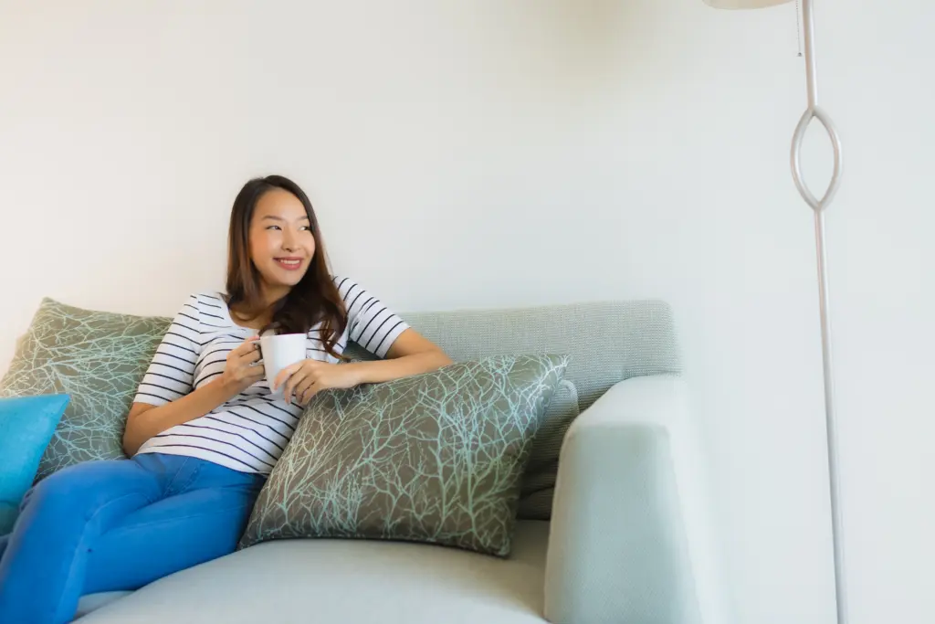 portrait beautiful young asian woman sofa with coffee cup - Living Space Sofa