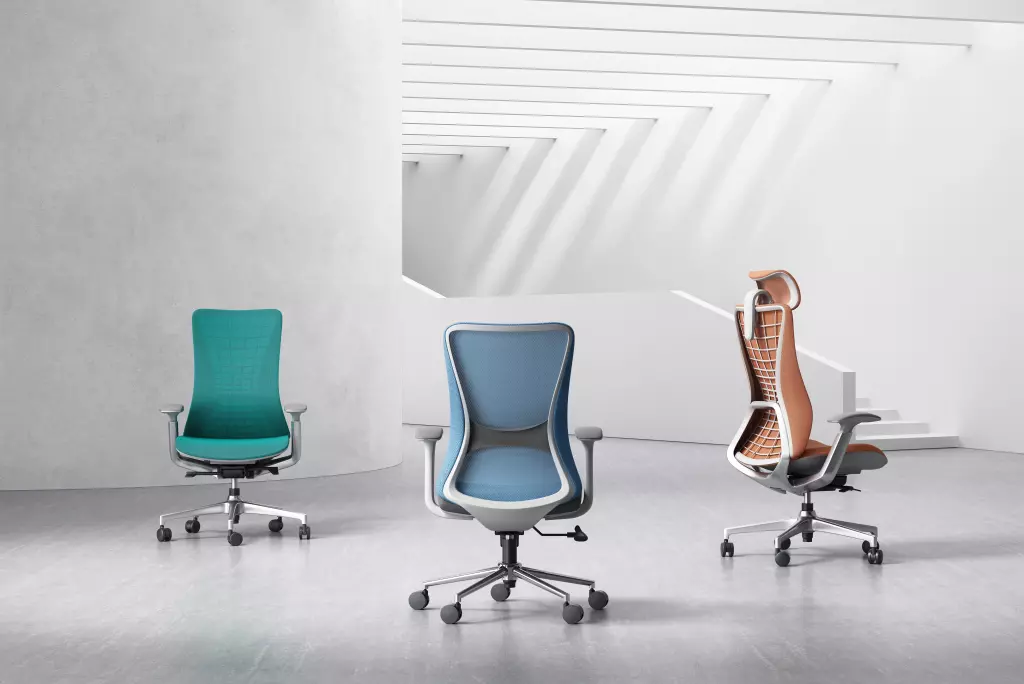Three ergonomic office chairs in vibrant colors—teal, blue, and orange—displayed in a minimalist workspace with clean lines and a modern design.