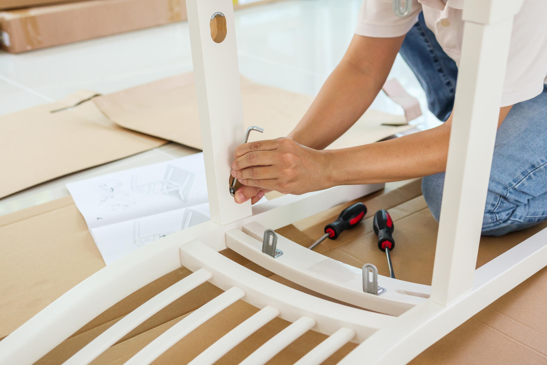 man assembling white chair furniture home scaled