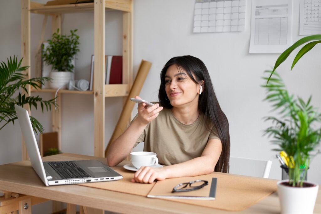 medium shot woman holding phone - Boho Chic Home Office, Boho Home Office