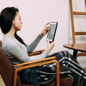 girl sits cosy chair black plaid - The best elvin leather recliner