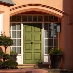 green front door salmon colored house