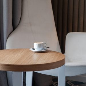 Side view cup of coffee on a small round table horizontal
