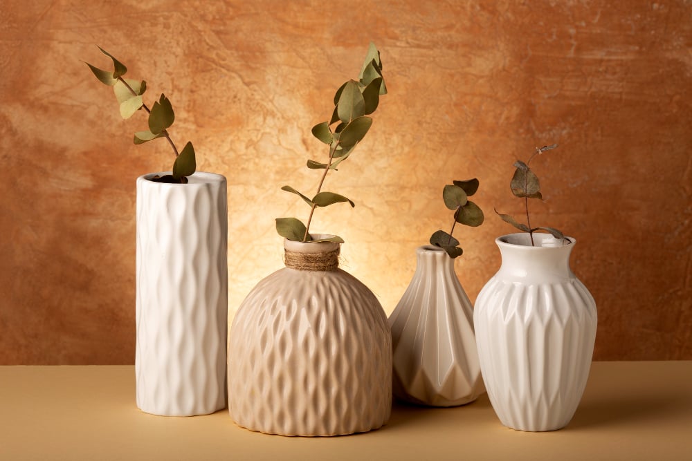 2149646509 | Sohnne® Neutral vases with dried branches adding a pop of color to simple apartment decor.