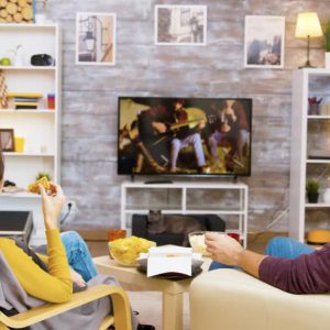 DIY TV stand setup with TV positioned at eye level for comfortable movie watching on a modern sofa.