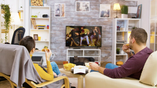diy-tv-stand-eye-level | Sohnne® DIY TV stand setup with TV positioned at eye level for comfortable movie watching on a modern sofa.