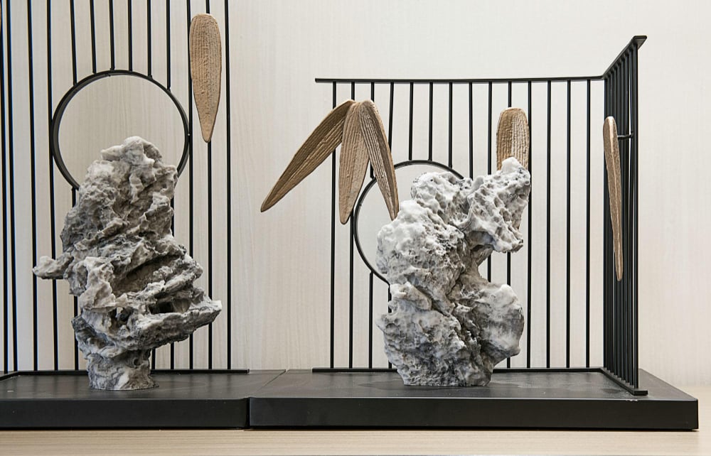 22754 | Sohnne® A tall sculpture placed between two seating areas. In this way, the art piece highlights split living room ideas that use design objects as soft dividers.
