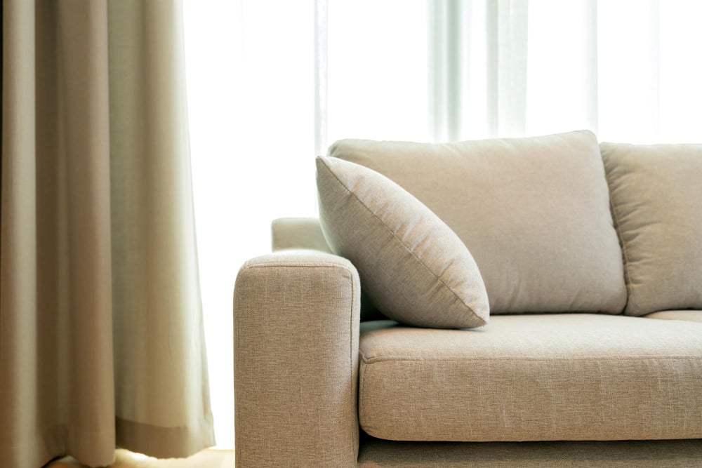 2296 | Sohnne® Beige sofa with soft edges and natural light highlighting apartment furniture cheap and modern living room design.