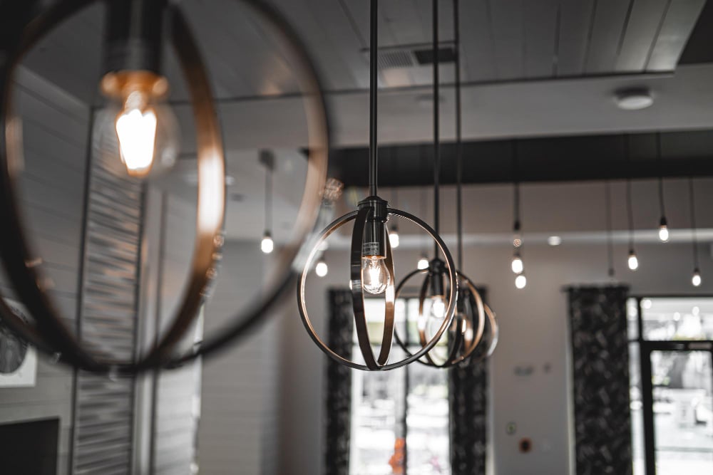 58123 | Sohnne® Pendant and floor lamps create a warm, layered glow. In addition, this lighting design supports split living room ideas that balance mood and usability.