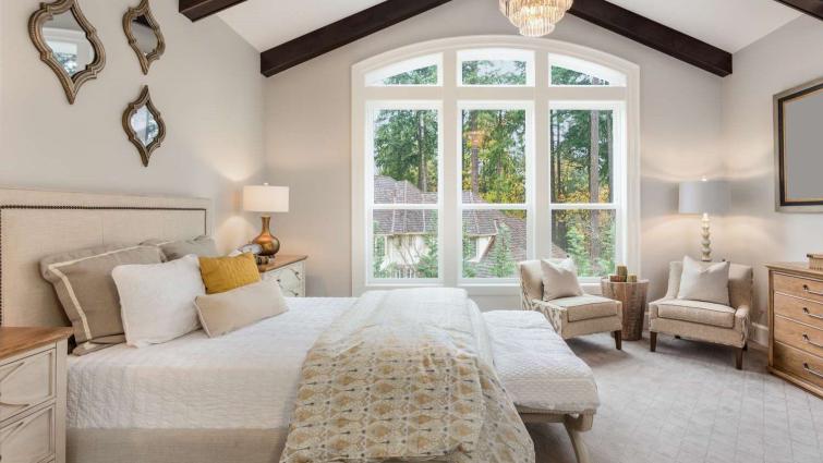 master bedroom in new luxury home with chandelier and large bank of windows with view of trees 1222623844 212940f4f89e4b69b6ce56fd968e9351 - bedroom essentials, comfort, sleep